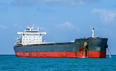 Cargo ship standing on the anchor.