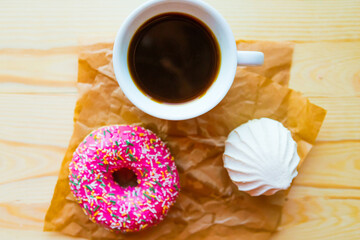 zefir, donut and coffee cup on crumpled paper, top view