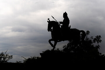 backlit shot of indian warrior maharana pratap statue at day from unique perspective