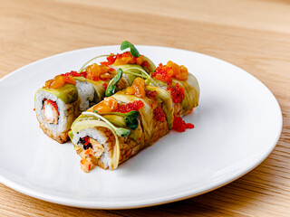 Tasty and beautiful sushi plate from the best sushi restaurant, the concept. Sushi rolls with rice and fish, soy sauce on a wooden table background. Overhead shot of Japanese seafood sushi set. 