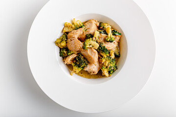 Vindaloo with spinach in white bowl isolated on white background. Portuguese Influenced Indian dish made by cooking chicken in vindaloo spice paste and broccolli.