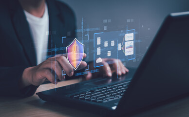 User shows security protection icon with virtual screen on notebook computer, concept of cyber...