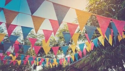 blur background colorful triangular flags of decorated celebrate outdoor party vintage tone