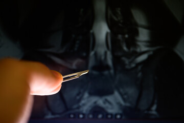 Radiological image of the scalpel in the back of a hand-held scalpel model - Powered by Adobe
