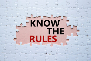 Know the rules symbol. Concept words Know the rules on white puzzle. Beautiful pink background....