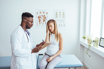 Fototapeta premium Doctor and patient discussing something at hospital . Medicine and health care concept. Doctor and patient. Patient Having Consultation With Doctor In Office.
