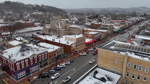 BEAVER, PA - December 19, 2023 - A wide winter aerial establishing shot of a small town's business district in Western Pennsylvania during the Christmas season. Pittsburgh suburbs.  	
