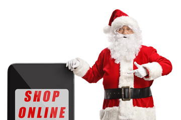 Santa claus leaning on a phone with text shop online and pointing