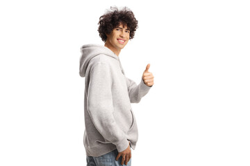 Guy with curly hair in a gray hoodie gesturing thumbs up