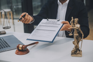 Business and lawyers discussing contract papers with brass scale on desk in office. Law, legal...