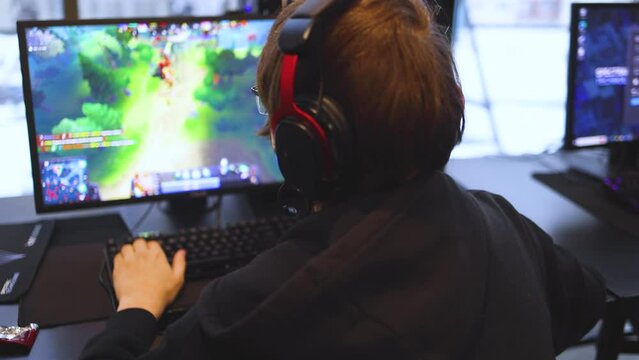 Cyber sport e-sports tournament, team of professional players, gamers playing online championship in competitive moba, strategy fps game in a cyber games arena club, person in a chair with pc