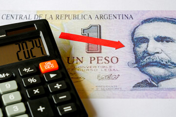 Concept of falling value of Argentine currency, symbol of rising inflation, falling purchasing power