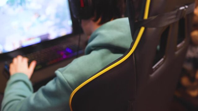 Cyber sport e-sports tournament, team of professional players, gamers playing online championship in competitive moba, strategy fps game in a cyber games arena club, person in a chair with pc