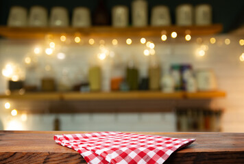 Empty wooden deck table and red checked tablecloth over mint wallpaper background. High quality...
