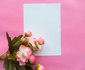 White mockup blank and bouquet of flowers on pink background. Valentine's Day , Mother's Day or Women's Day greeting card