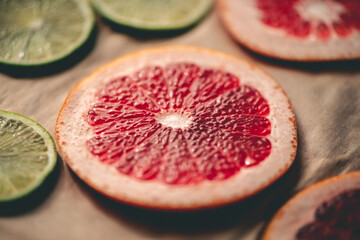 Sliced orange, tangerine and grapefruit slices on baking sheet, preparing citrus wedges for...