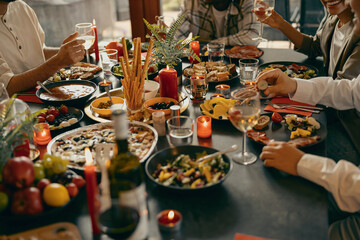 Cozy holiday table setting with different delicious food and beverages ready for friends home party