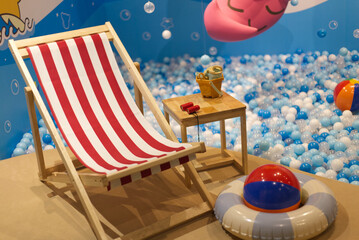 beach chair on a pastel blue bubble ball pool 