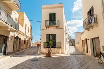 Urban street with typical mediterranean houses on the island Favignana in Sicily, province of...