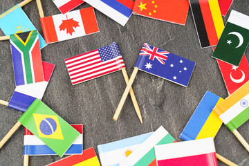 Fototapeta na wymiar The concept is diplomacy. In the middle among the various flags are two flags - USA, Australia