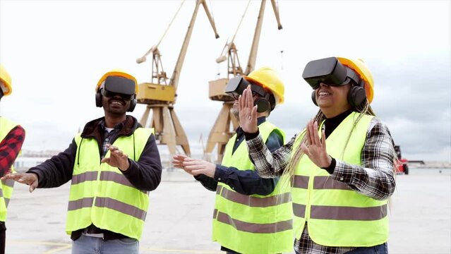 Video portrait of multiethnic coworkers in charge of container transportation using virtual reality glasses: teamwork concept
