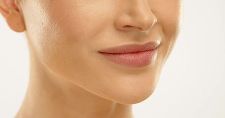 Close up of a smile. A girl with perfect skin turns her head towards the camera and smiles, revealing her beautiful smile and perfectly straight, white teeth. Dental clinic advertisement. 4K