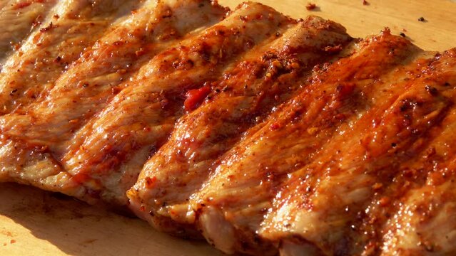 Barbecue sauce spread on raw ribs for cooking over an open fire