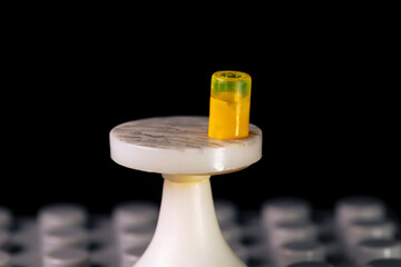 Miniature toy table with an orange drink in a glass
