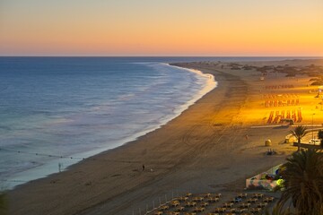 Playa del Ingles beach at sunset in Maspalomas, Gran Canaria, Spain