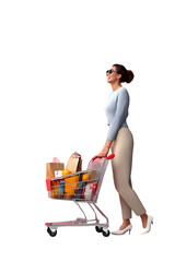 Full length profile shot of a young woman walking with a shopping basket with food products.