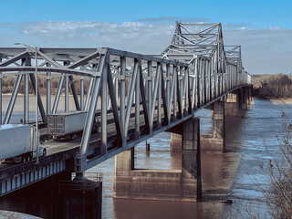 Mississippi welcome and farewell bridge with blue skies and heavy white clouds low water traveling...