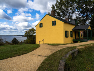 Fototapeta na wymiar The intensely yellow visitor center house at Fort Washington, Virginia, overlooking the Potomac River.