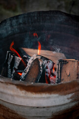 Fire place in old rusty barrel providing heat for people outside in the cold winter weather.