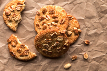 Tasty round cookies with nuts on crumble paper