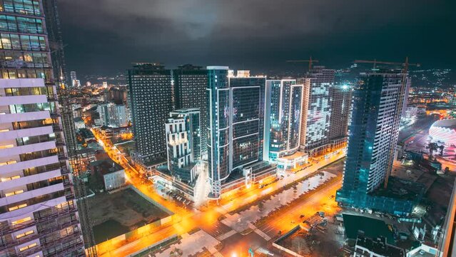 Evening Night City Traffic. Night View Scenic Of Skyscraper background timelapse time lapse . Street Night Time Lapse. City Traffic and highrise houses . Elevated View Cityscape Skyline. Night Light