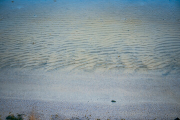 Close up white sand beach and waves concept photo. Country side resort.