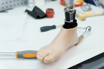 A close-up of a prosthetic foot amidst various tools, showcasing the precise work of prosthetic...
