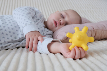 A baby is sleeping in a crib, a child of European appearance, wearing a light light jumpsuit. A...