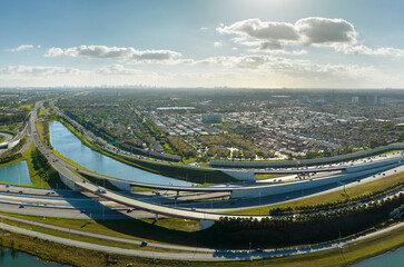 Aerial view of american highway junction with fast driving vehicles in Miami, Florida. View from...