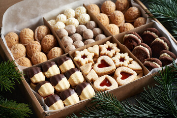 Variation of handmade Christmas cookies in a gift box on a table
