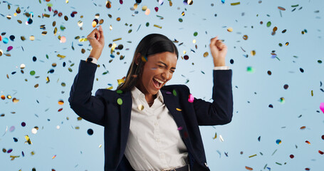Happy business woman, confetti and celebration for winning or promotion against a blue studio...