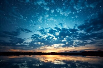 Beautiful sunset over sea with reflection in water, majestic clouds in the sky. Dramatic cloudscape over water. Beauty and power of nature. Blue Orange Contrast.