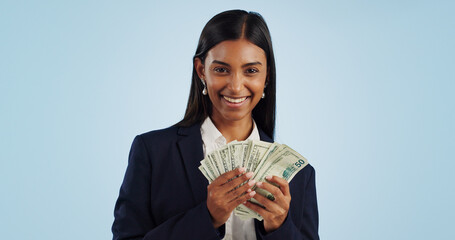 Business woman, portrait and money in financial freedom against a blue studio background. Happy...