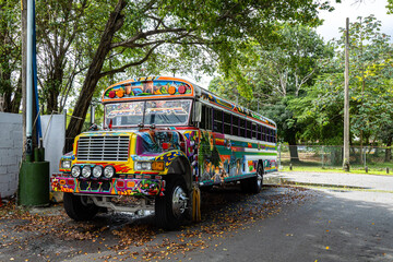 Multi-colored urban bus parked on a park