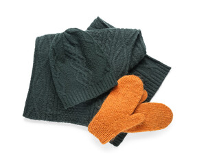 Pair of orange knitted mittens with warm hat and scarf on white background