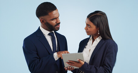 Collaboration, tablet and a professional business team in studio on a blue background for problem solving. Technology, data or feedback with a corporate man and woman talking about information