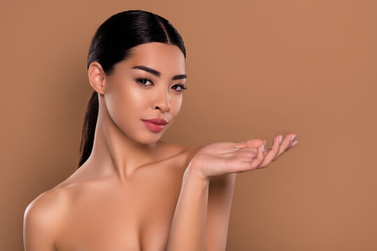 Photo of gorgeous lovely lady arm demonstrate promo empty space beauty salon facial isolated on beige color background