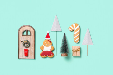 Fototapeta na wymiar Beautiful composition with gingerbread cookies, Christmas fir tree and different decorations on turquoise background
