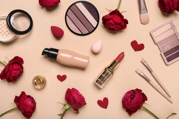 Obraz na płótnie Canvas Cosmetic products with red roses and hearts on beige background. Valentine's day celebration