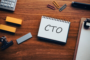 There is notebook with the word CTO. It is an abbreviation for Chief Technology Officer as eye-catching image.